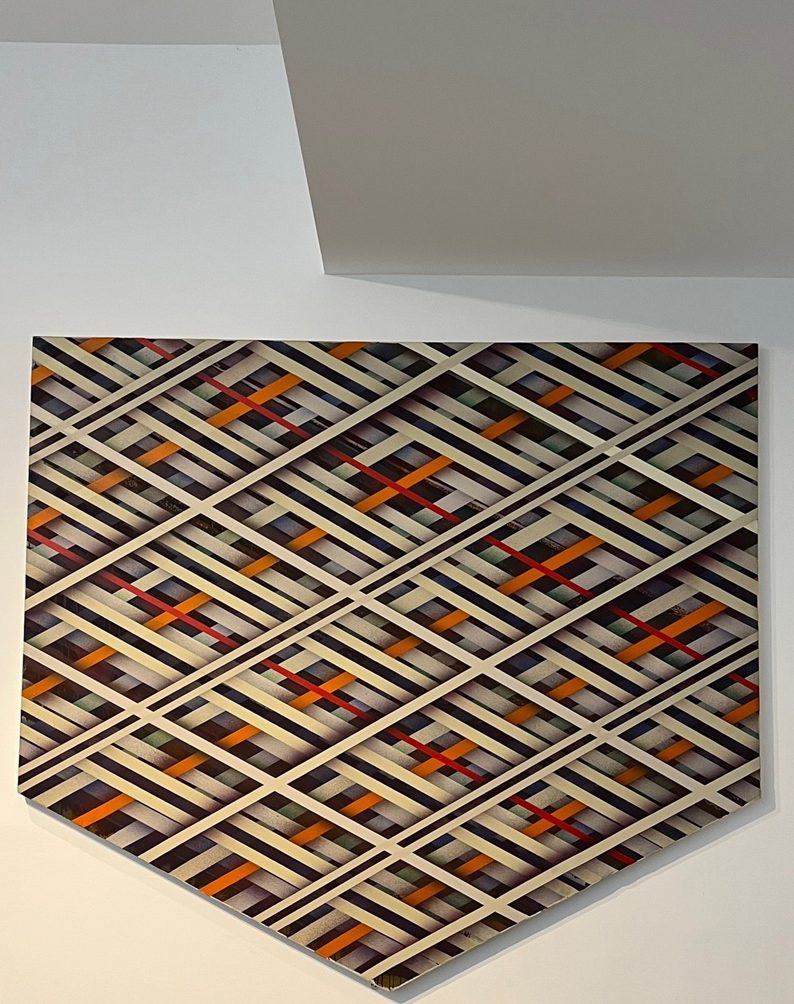 East Coast Light 1973 by Sean Scully, an abstract painting of geometric bands of cream, red and orange on a dark background. On display is a white gallery at Houghton Hall. Photo: Sarah Simpkin